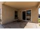 Covered outdoor patio area perfect for relaxation and entertaining, with sliding glass doors at 17828 W Calavar Rd, Surprise, AZ 85388
