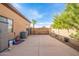 Large backyard area features a simple fence, palm tree, and rock landscaping at 18029 W San Miguel Ave, Litchfield Park, AZ 85340