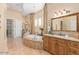 Luxurious bathroom showcasing a tub, dual sinks, and a separate shower, designed for relaxation and comfort at 18029 W San Miguel Ave, Litchfield Park, AZ 85340