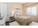 Inviting bedroom with a cozy bed, soft lighting, and a window, creating a serene and relaxing atmosphere at 18029 W San Miguel Ave, Litchfield Park, AZ 85340