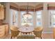 Cozy dining area with large windows and a decorative chandelier at 18029 W San Miguel Ave, Litchfield Park, AZ 85340
