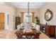 Formal dining room featuring hardwood floors, elegant lighting, and decorative accents at 18029 W San Miguel Ave, Litchfield Park, AZ 85340