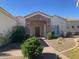 Inviting front entrance with stone archway, manicured landscaping, and brick paver walkway at 18029 W San Miguel Ave, Litchfield Park, AZ 85340