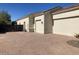 Spacious driveway leading to a three car garage at 18029 W San Miguel Ave, Litchfield Park, AZ 85340