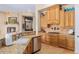 Bright kitchen with custom cabinets, granite countertops, and a tile backsplash at 18029 W San Miguel Ave, Litchfield Park, AZ 85340