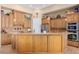 Spacious kitchen island with custom cabinets, granite countertops, and stainless steel appliances at 18029 W San Miguel Ave, Litchfield Park, AZ 85340