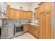 A spacious laundry room has ample storage and stainless steel appliances at 18029 W San Miguel Ave, Litchfield Park, AZ 85340