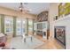 Comfortable living room with a fireplace, large windows, and access to the patio at 18029 W San Miguel Ave, Litchfield Park, AZ 85340