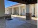 View from outdoor kitchen to rear of home with covered patio and windows at 18029 W San Miguel Ave, Litchfield Park, AZ 85340