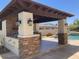 A stone outdoor kitchen area sits next to the pool at 18029 W San Miguel Ave, Litchfield Park, AZ 85340