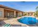 The backyard boasts a large luxurious pool and an outdoor seating area at 18029 W San Miguel Ave, Litchfield Park, AZ 85340