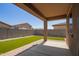 Relaxing covered patio overlooking the artificial grass backyard, perfect for low maintenance living at 18637 W Williams Rd, Surprise, AZ 85387