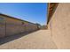 Long backyard area featuring a block wall, gravel, and minimal landscaping at 18637 W Williams Rd, Surprise, AZ 85387