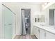 Elegant bathroom with double sinks, white cabinetry, and a glass-enclosed shower, offering serene space at 18637 W Williams Rd, Surprise, AZ 85387