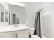 Neutral bathroom features a shower with curtain, toilet and vanity with sink and mirror at 18637 W Williams Rd, Surprise, AZ 85387