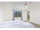 Bright bedroom featuring neutral walls, a ceiling fan, and a door to the backyard at 18637 W Williams Rd, Surprise, AZ 85387