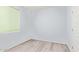 Small light blue bedroom with light wood floors and a window at 18637 W Williams Rd, Surprise, AZ 85387