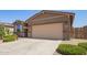 Picture of the facade of a one-story home with neutral paint and a two-car garage at 18637 W Williams Rd, Surprise, AZ 85387