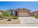 Charming single-story home with a well-manicured front yard and a two car garage at 18637 W Williams Rd, Surprise, AZ 85387