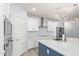 Well-lit kitchen featuring stainless appliances, white cabinets, and a large island with a sink at 18637 W Williams Rd, Surprise, AZ 85387