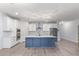 Spacious kitchen with a blue island, stainless steel appliances, and modern lighting at 18637 W Williams Rd, Surprise, AZ 85387