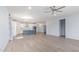 Bright living room with luxury vinyl plank flooring, large windows, and neutral paint at 18637 W Williams Rd, Surprise, AZ 85387