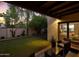 Enjoy the serene backyard with lush lawn and covered patio, perfect for outdoor gatherings and relaxation at 2110 W Navarro Ave, Mesa, AZ 85202