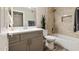 Modern bathroom featuring a shower over bath, plant decor, a sink with a large mirror and stylish wooden flooring at 2110 W Navarro Ave, Mesa, AZ 85202