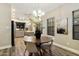 Open dining room featuring modern lighting and seamlessly connected to the kitchen at 2110 W Navarro Ave, Mesa, AZ 85202