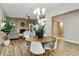 Dining room with modern decor, chandelier, and seamlessly connected to the living area at 2110 W Navarro Ave, Mesa, AZ 85202