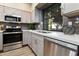 Modern kitchen with stainless steel appliances, quartz countertops, and stylish cabinetry at 2110 W Navarro Ave, Mesa, AZ 85202
