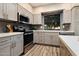 Renovated kitchen features stainless steel appliances, sleek countertops, and stylish gray cabinetry at 2110 W Navarro Ave, Mesa, AZ 85202