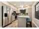 Contemporary kitchen boasts stainless steel appliances, an island with seating, and ample cabinet space at 2110 W Navarro Ave, Mesa, AZ 85202