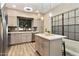 Bright kitchen with stainless steel appliances, gray cabinets, and a spacious island with seating at 2110 W Navarro Ave, Mesa, AZ 85202
