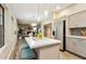 Open-concept kitchen with an island, stainless steel appliances, and seamless access to the living spaces at 2110 W Navarro Ave, Mesa, AZ 85202