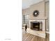 Cozy living room with an elegant stone fireplace and contemporary wall decor at 2110 W Navarro Ave, Mesa, AZ 85202
