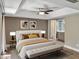 Spacious bedroom featuring a ceiling fan, ensuite bath, neutral walls and elegant furnishings at 2110 W Navarro Ave, Mesa, AZ 85202