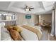 Large bedroom featuring wood floors, TV, sitting area, ensuite bathroom with double sinks at 2110 W Navarro Ave, Mesa, AZ 85202