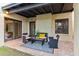 Relax on this covered patio with stylish seating, overlooking the well-maintained backyard and lush landscaping at 2110 W Navarro Ave, Mesa, AZ 85202