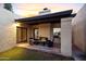 Charming covered patio with comfortable seating, perfect for relaxing and enjoying the outdoor ambiance at 2110 W Navarro Ave, Mesa, AZ 85202