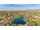 Panoramic aerial view of the neighborhood overlooking a golf course, lush green space, and tranquil lake at 22204 N 55Th St, Phoenix, AZ 85054