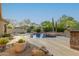 Beautiful backyard oasis featuring a private pool, waterfalls, fire pit, lush desert landscaping and stone accents at 22204 N 55Th St, Phoenix, AZ 85054