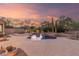 Expansive backyard with a pool, fire pit, lush desert landscaping, and tranquil ambiance at 22204 N 55Th St, Phoenix, AZ 85054