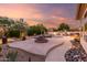 Backyard featuring a pool, fire pit, desert landscaping, and an outdoor kitchen area at 22204 N 55Th St, Phoenix, AZ 85054