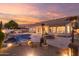 Resort-style backyard with a sparkling pool, spa, fire pit, and covered patio, perfect for outdoor living at 22204 N 55Th St, Phoenix, AZ 85054
