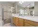 Bathroom featuring a glass enclosed shower with a tile surround and bench seating at 22204 N 55Th St, Phoenix, AZ 85054