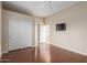 Bedroom with hard wood floors has mirrored closet and a mounted television at 22204 N 55Th St, Phoenix, AZ 85054