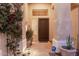 Front entrance featuring a decorative security door, lush plants, and a well-lit pathway at 22204 N 55Th St, Phoenix, AZ 85054