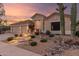 Home's exterior with desert landscaping and a large cactus, stone pathway and a neutral color scheme at 22204 N 55Th St, Phoenix, AZ 85054