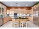Bright kitchen with custom cabinets, an island with seating, and stainless steel appliances at 22204 N 55Th St, Phoenix, AZ 85054